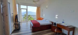 a bedroom with a bed and a desk and a window at Mist Farm Resort in Avanāshi +13 photos