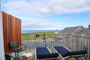 a balcony with chairs and a view of the ocean at The Morgan Hotel Martha's Vineyard in Oak Bluffs +26 photos