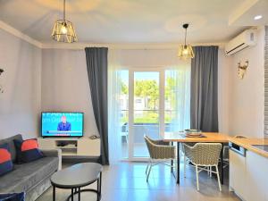 a living room with a couch and a table at Wide Beach Apartments 236 in Mullini i Danit