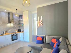a living room with a couch and a table at Wide Beach Apartments 236 in Mullini i Danit