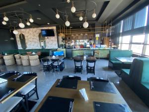 a restaurant with tables and chairs and a bar at Hotel Sun in Encarnación