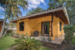 a small yellow house with a patio at Bahia Esmeralda Boutique Hotel & Villas in Potrero