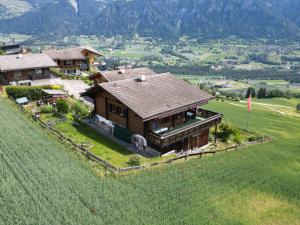 an aerial view of a house in a field at Haus Chalet Beverin in Cazis