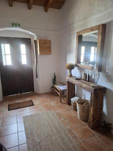a room with a door and a mirror and a tile floor at Casa do Chico in Mértola +32 photos