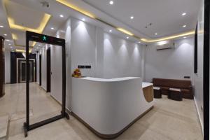 a lobby with a white counter and a couch at Hotel Namaskar India - Just A Minute Away From New Delhi Railway Station & Connaught Place in New Delhi