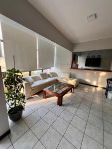a living room with a couch and a coffee table at Hotel Qamiri in Arica