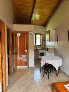 a kitchen with a table and chairs in a room at Apartamentos El Campal in Felechosa +102 photos