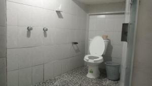 a bathroom with a white toilet in a stall at Hostal mandala Evelyn in El Pacífico