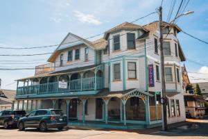 a large house with a balcony on a street at The Morgan Hotel Martha's Vineyard in Oak Bluffs