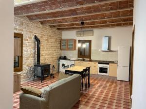 a living room with a couch and a table in a kitchen at Masia La Sort in Riba-roja d'Ebre