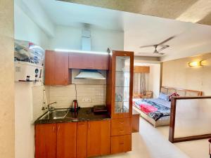 a kitchen with a sink and a room with a bed at ZenRoofs - Brij Bhumi Haven 1 in Vrindāvan