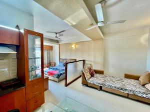 a living room with two beds and a mirror at ZenRoofs - Brij Bhumi Haven 1 in Vrindāvan +9 photos