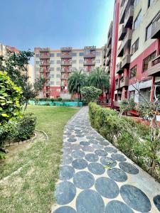 a cobblestone path in a city with buildings at ZenRoofs - Brij Bhumi Haven 1 in Vrindāvan