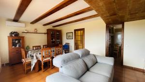 a living room with a couch and a table at Casa la Borna in Begur