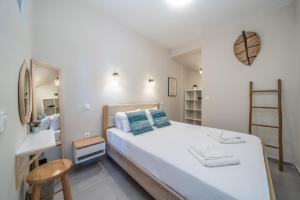 a bedroom with a large bed and a mirror at Tassos Cottage Fiskardo in Fiskardo