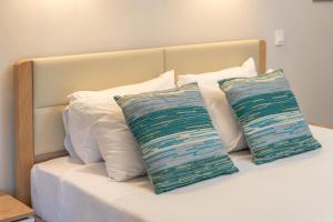 a bed with two pillows on top of it at Tassos Cottage Fiskardo in Fiskardo +30 photos
