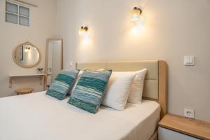 a bedroom with a bed with two pillows on it at Tassos Cottage Fiskardo in Fiskardo