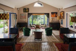 a living room with couches and a table and chairs at La Villa Mandarine in Rabat