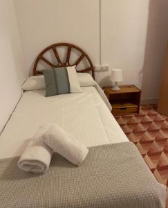 a bedroom with a bed with a towel on it at Masia La Sort in Riba-roja d'Ebre +20 photos