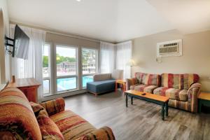 a living room with two couches and a table at Ogunquit Tides in Ogunquit