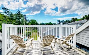 a white deck with two chairs and a table at Ogunquit Tides in Ogunquit