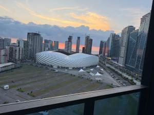 a large building in a city with a parking lot at Fantastico 270 in Batumi