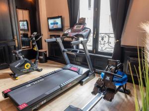 a gym with two tread machines and a treadmill at Mercure Le Mans Centre in Le Mans