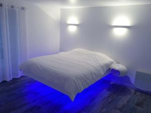 a bedroom with a bed with two lights on the wall at L'inattendu in Les Piards +23 photos