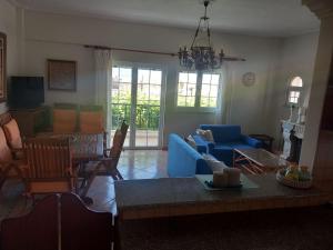 a living room with a blue couch and a table at Mytikas villa in Kandíla +9 photos
