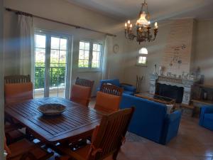 a living room with a table and a blue couch at Mytikas villa in Kandíla