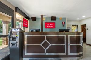 a hotel lobby with a counter and a cash register at Red Roof Inn Gastonia in Gastonia +26 photos