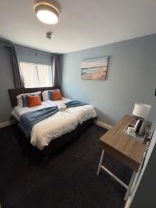 a bedroom with a bed and a table in it at The Pod on John St in Wexford +3 photos