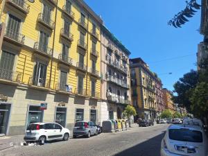 a city street with cars parked in front of buildings at Relais Principe Umberto in Naples