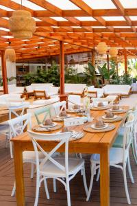 a wooden table and chairs on a patio at Koko Beach - Honeymoon Suite in Vila Praia Do Bilene