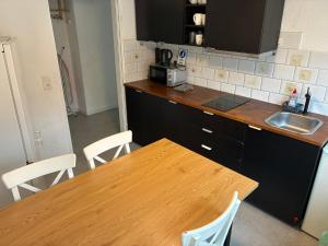 a kitchen with a wooden table and a sink at Hauckwald Apartment 1 in Alzenau