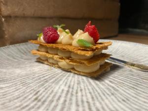 a stack of sandwiches with fruit on a plate at Tiiupesa Guest House in Hellamaa