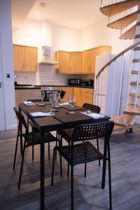 a dining room table with chairs in a kitchen at Luton Grove in Liverpool