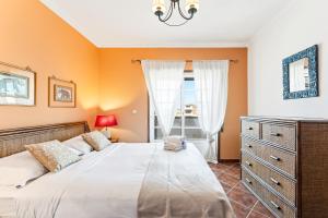 a bedroom with a bed and a dresser and a window at Salt & Sand Costa Nova Beach in Costa Nova