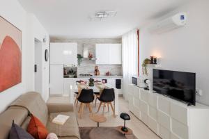 a living room with a couch and a table with chairs at Brezza della Fortuna in Fano