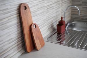 a wooden cutting board next to a sink at Brezza della Fortuna in Fano +11 photos