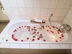 a bath tub with red and white balls in it at Le Noyer in Lierneux +40 photos