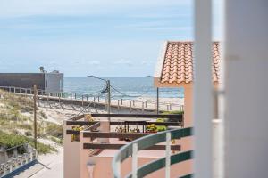 a balcony with a view of the beach at Salt & Sand Costa Nova Beach in Costa Nova