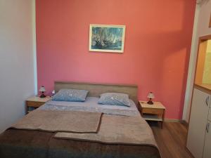 a bedroom with a bed and a painting on the wall at Tivoli Apartment in Ičići