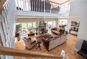 a living room with couches and a staircase at The Iveragh in Kenmare