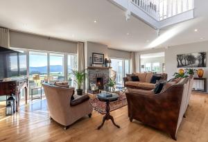 a living room with a couch and chairs and a fireplace at The Iveragh in Kenmare