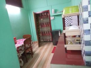 a toy kitchen with a table and a refrigerator at niribili homestay in Dibrugarh