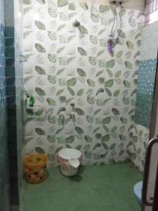 a bathroom with a shower with a sink and a toilet at niribili homestay in Dibrugarh