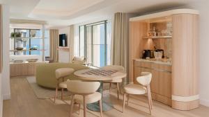 a kitchen and dining room with a table and chairs at Hotel Palais de la Mediterranee, in the Unbound Collection by Hyatt in Nice