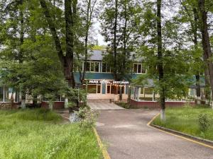 a house with a driveway in front of it at Park Hotel in Quba