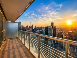 a balcony with a view of a city skyline at Altitude Suites on Yonge - Downtown Toronto Short Walk to SickKids, TMU & Eaton Centre in Toronto